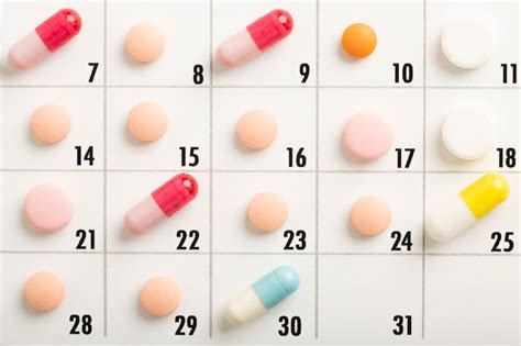 Premium Photo Pills Are Of Different Color On The Calendar Schedule