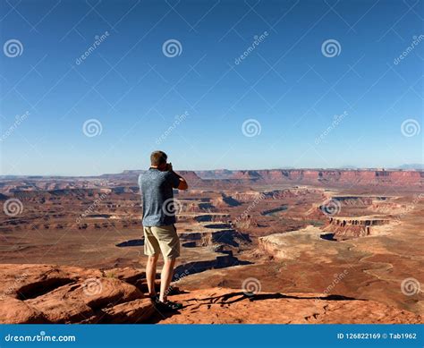 Mature Man Taking Photos Of The Grand Canyon During Nice Summer Stock