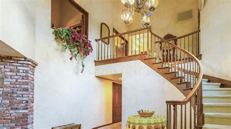 Panorama Frame Spiral Stairs In Rustic Entry Of A Luxurious California