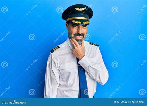 Middle Age Man With Beard And Grey Hair Wearing Airplane Pilot Uniform