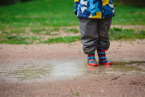 Child Playing In Muddy Puddle Stock Image Image Of Rainboots Active