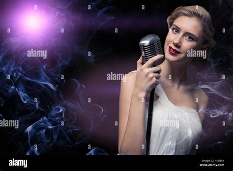 Attractive Female Singer With Microphone Stock Photo Alamy