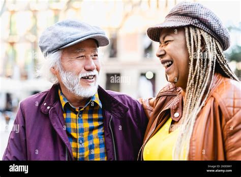 Happy Multiracial Senior Couple Having Fun In City Elderly People And