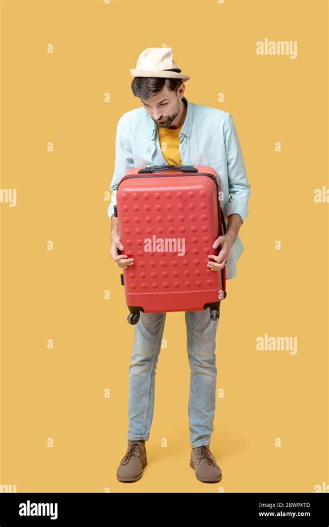 Sad Man Clutching A Suitcase Looking Down Stock Photo Alamy