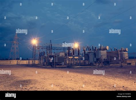 Electrical Power Substation Illuminated By Lights At Night Deliver