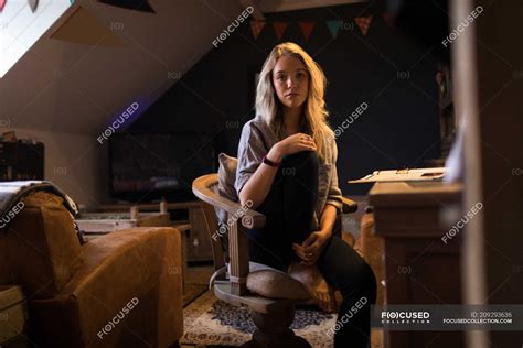 Portrait Of Young Woman Sitting On Chair — Indoors Authentic Stock