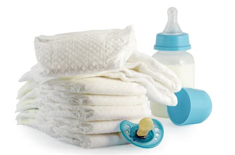 A Stack Of Baby Diapers Bottle And A Pacifier Stock Photo Download