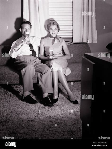 1950s Couple Sitting On Sofa Drinking Beers Watching Television F3164 Har001 Hars Females