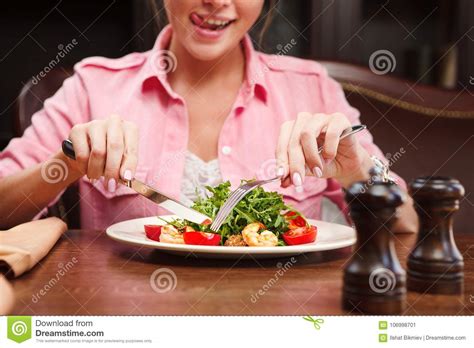Delighted Woman Show Tongue And Going To Eat Salad With Arugula Stock
