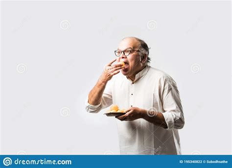 Indian Old Man Eating Phuchka Panipuri Gupchup Or Golgappa Royalty