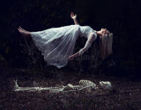 Levitation Image Of A Woman Rising From A Skeleton On Dead Leaves Stock