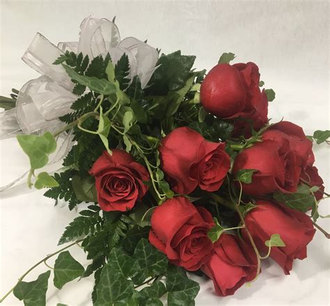 Dozen Red Standard Roses Wrapped With Mixed Greenery Water Viles And A