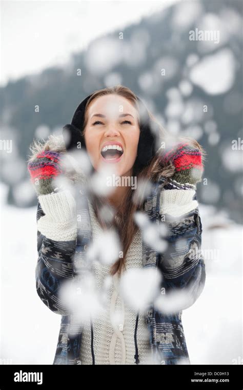 Enthusiastic Woman Enjoying Falling Snow Stock Photo Alamy