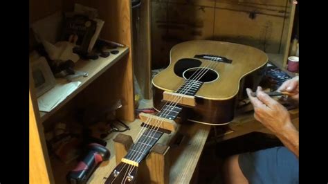 Loosen the strings a bit to relieve tension, then increase the string action by making adjustments at the string saddles (located on the bridge). Sigma acoustic guitar from 1970 Stop fret buzz with your ...