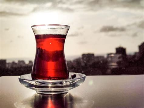 Premium Photo Turkish Tea In Glass In Shape Of Armudu Stands On Table