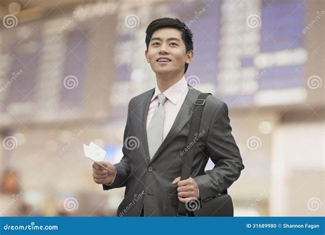 Young Businessman Holding Ticket At The Airport Beijing China Stock