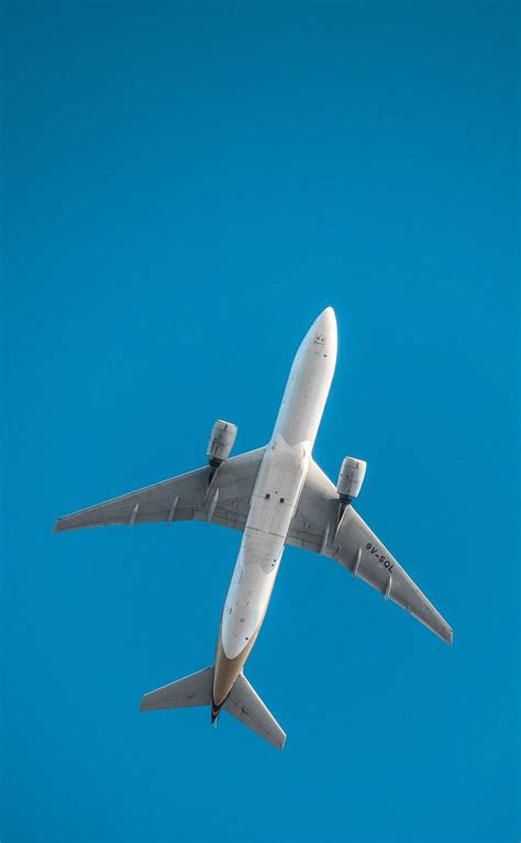Download Low Angle Shot Of White Airplane Android Wallpaper