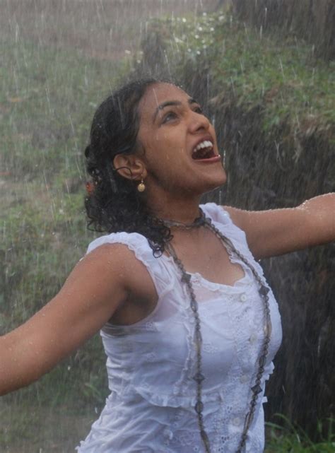 Navel Show Nithya Menon New Wet Photos In Rain Song
