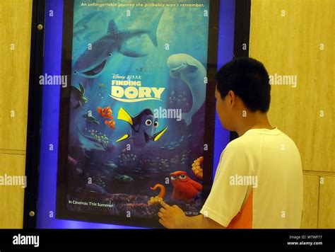 File A Chinese Filmgoer Walks Past A Poster Of The American 3d