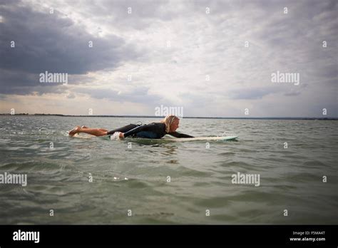 Woman Lying On Surfboard In Hi Res Stock Photography And Images Alamy