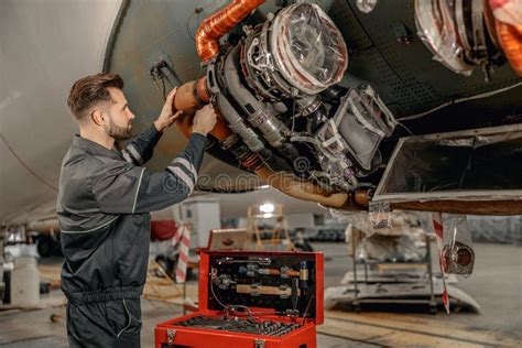 Male Aviation Mechanic Repairing Airplane In Hangar Stock Photo Image