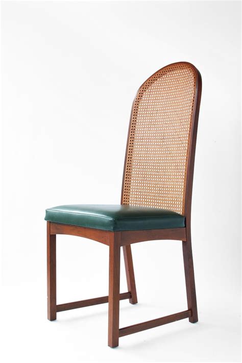 Viewed as a vintage french style, this chair is rather elegant in its design with piping detail around the chair. Milo Baughman Oval Back Cane Dining Chairs For Sale at 1stdibs