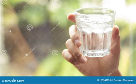 Hand Holds Clear Water In Glass Hand Holding A Clear Glass Of Clean
