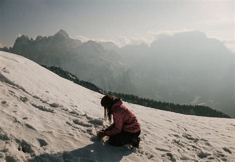 Girl Playing In The Snow On Top Of Mountain Del Colaborador De Stocksy Martin Matej Stocksy