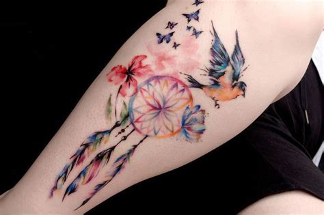 A Womans Arm With A Watercolor Tattoo Design On The Left Side Of Her Body