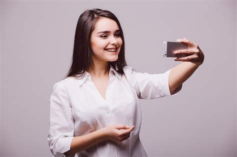 Free Photo A Smiling Young Attractive Woman Holding A Digital Camera