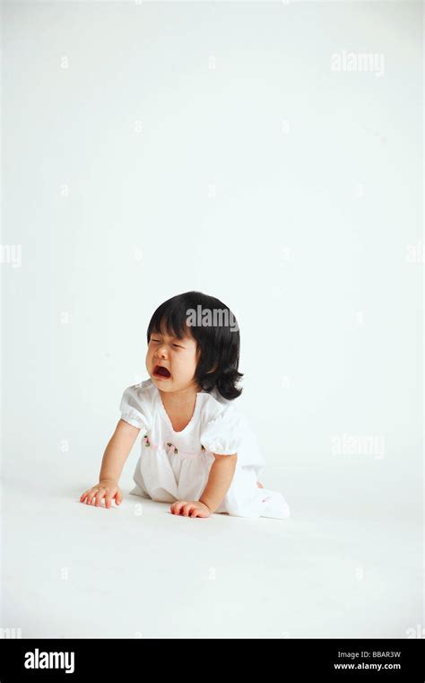 Baby Girl Crawling On Floor Crying Stock Photo Alamy