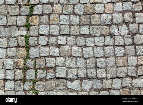 A Sidewalk Made Of Granite Stone A Road With A Pattern Of Square Tiles
