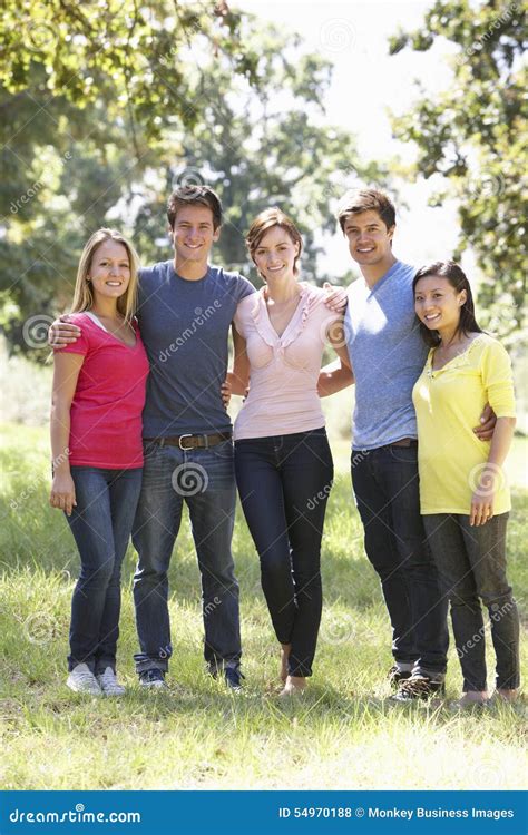 Group Of Young Friends Walking Through Countryside Stock Photo Image