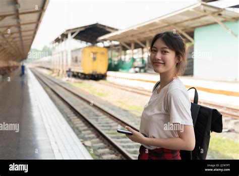 Portrait Young Asian Woman Backpacker Travel At Train Station Stock