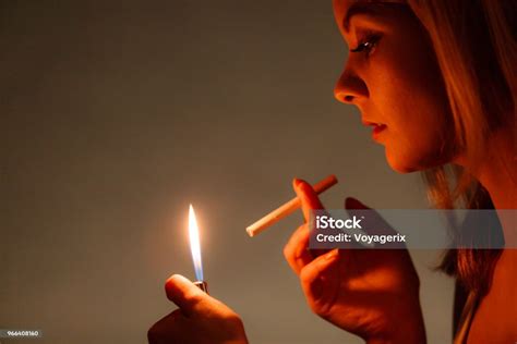 Pretty Girl Smoking Cigarette Using Lighter Stock Photo Download