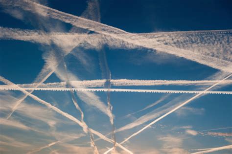 Airplane Trails Of Condesed Air In The Sky Stock Photo Download Image