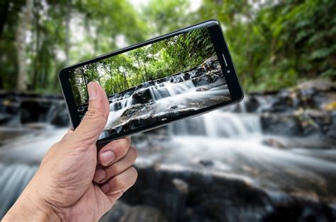 Premium Photo Hand Holding Smartphone Landscape Nature Background