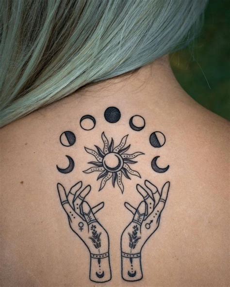 Moon Phases Sun And Hands Tattoo On The Upper Back