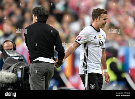 germany coach joachim loew left shakes hands with germany s mario goetze as he leaves the