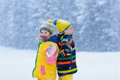 Kids Playing In Snow Children Play In Winter Stock Image Image Of