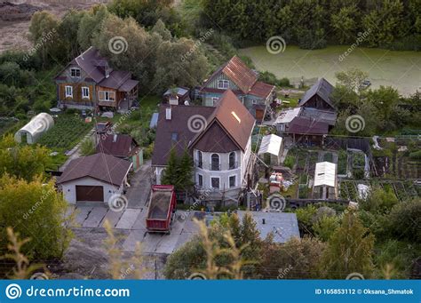 Small Town With Tiny Houses Near The River And Green