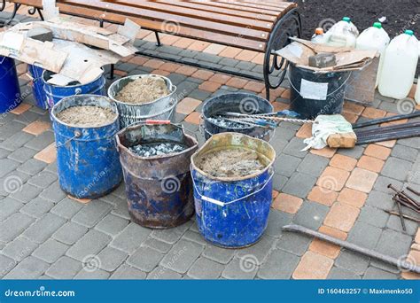 Tools For Repairing Sidewalk Bucket Of Sand Rubble On City Street