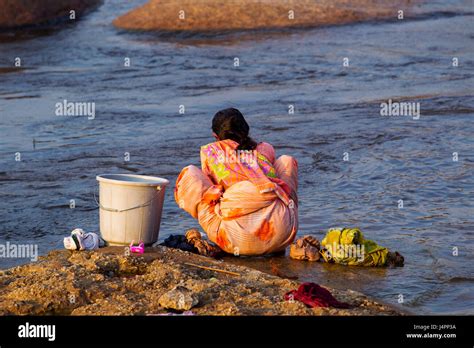 Indian Woman Washing Clothes At Tungabhadra River Hampi Karnataka