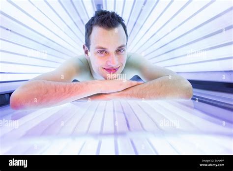 Handsome Young Man Relaxing During A Tanning Session In A Modern