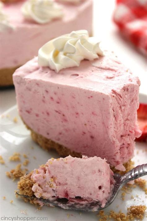 A Slice Of Strawberry Cheesecake On A Plate With A Fork