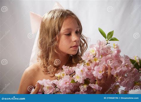 Portrait Of Cute Kid Girl Posing In Pink Beautiful Dress On A White