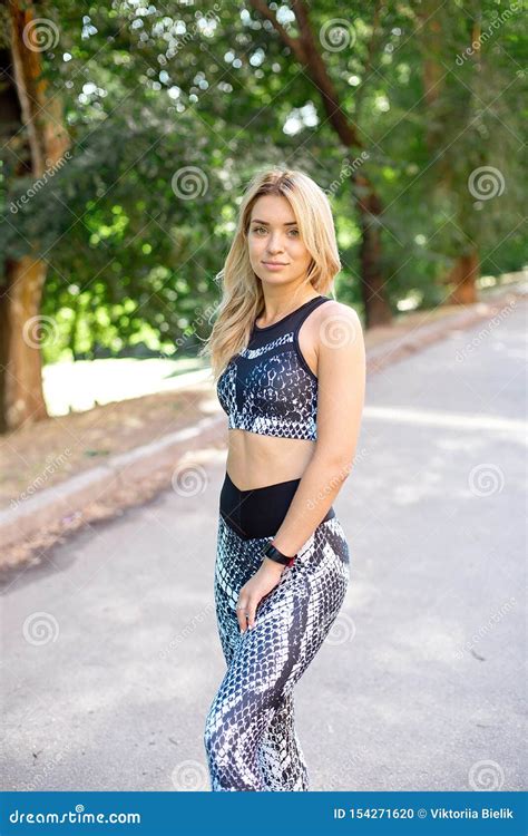 Young Slim Woman With A Sporty Body Long Blond Hair Dressed In A