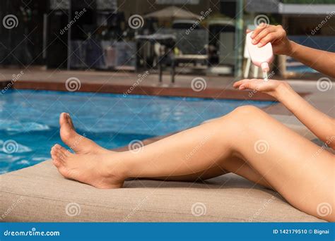 Woman Applying Sunscreen Lotion On Her Hand By Swimming Pool On Vacation Stock Photo Image Of