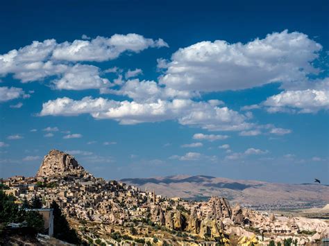 Landscape With Houses In Stones Under Sky And Clouds In Cappadocia
