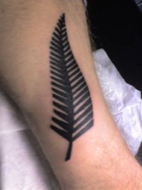 A Mans Arm With A Black Fern Tattoo On The Left Side Of His Arm